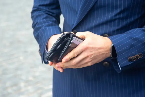 stock image businessman in a suit opens his business leather wallet close up