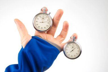 hand with a mechanical stopwatch on a white background. Time part precision. Measurement of the speed interval