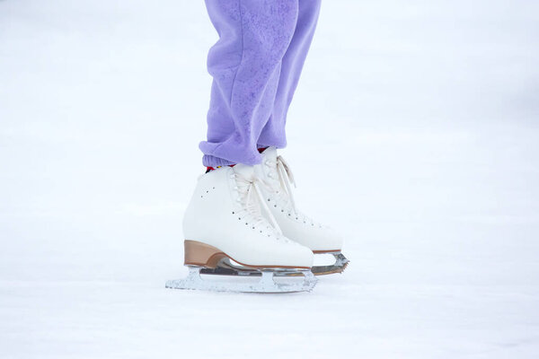 legs of a skater on an ice rink. hobbies and winter sports