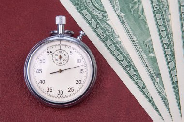 mechanical stopwatch on the background of dollars. Part time accuracy for business. business and finance time.
