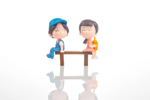 stock image miniature people. figures for the game. romantic couple of young people. Boy and girl sitting on a bench