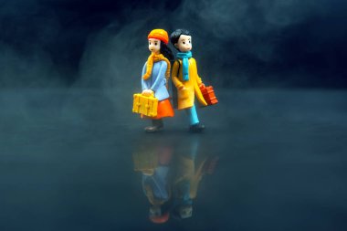 miniature people. figures for the game. romantic couple of young people. boy and girl walking together