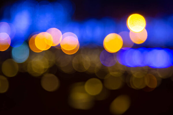 Background blurred abstraction of colored lanterns and decorations. bokeh texture of street colored lights