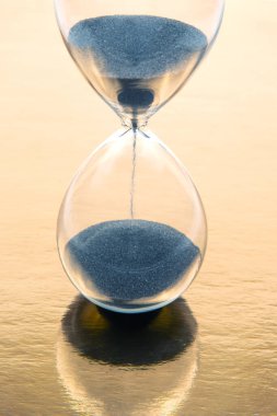 hourglass on a golden background. time and minute measurement