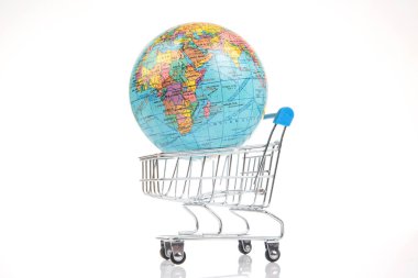 earth world globe in a grocery basket with dollars on a white background. the concept of the sale of land resources. worldwide sales business