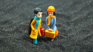 miniature people. figures for the game. romantic couple of young people. boy and girl walking together