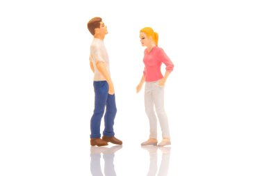 miniature people. figures of a man and a woman on a white background. communication and relationship building. problems in communication.