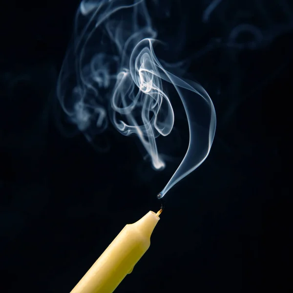 stock image Smoke from an extinguished candle on a dark background. The concept of spirituality and the end of life.
