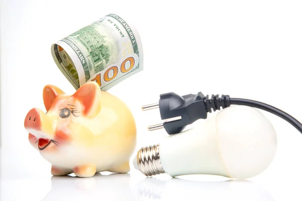 stock image Piggy bank, LED lamp and electric cable plug. Saving electricity. Energy saving concept