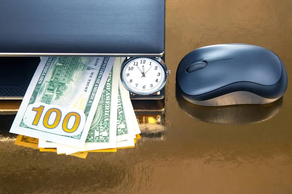 Dollars, wristwatch near laptop with mouse. Business online. Working time for working with laptop.