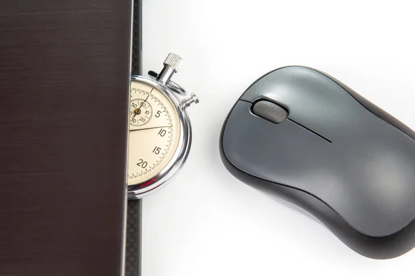 Stopwatch and laptop with a mouse on a white background. Time control for work and games online