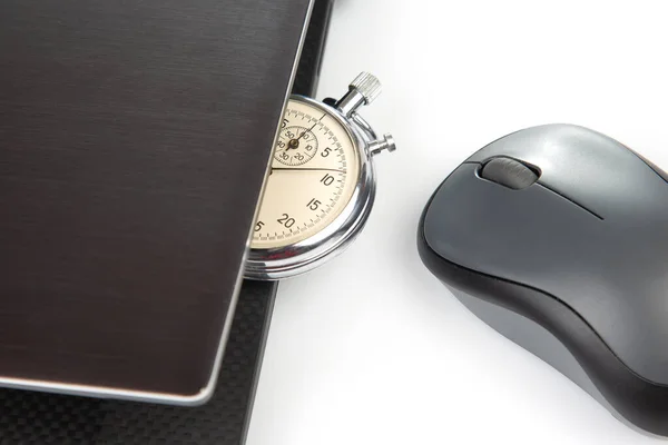Stopwatch and laptop with a mouse on a white background. Time control for work and games online