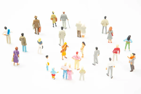 miniature people. different people stand on a white background. people communicate with each other. communication of society of different generations