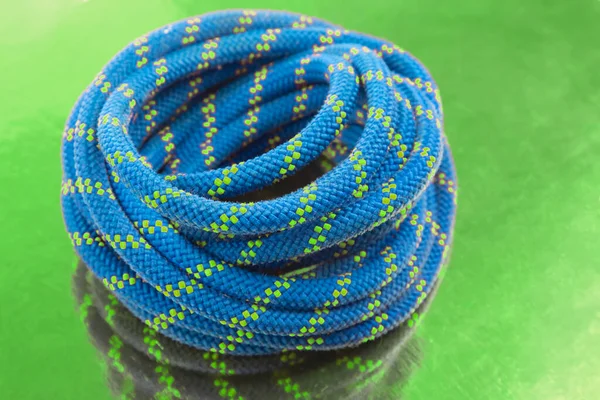 durable colored rope for climbing equipment. knot of braided cable. item for tourism and travel