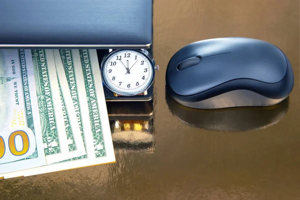 Dollars, wristwatch near laptop with mouse. Business online. Working time for working with laptop.
