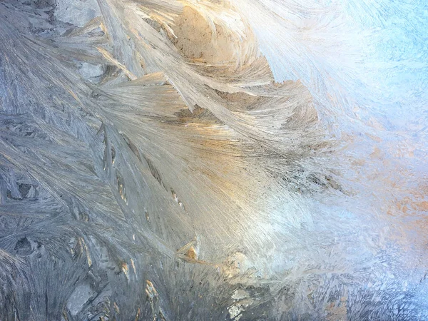 Stock image frosty patterns on the window glass closeup. natural textures and backgrounds. ice patterns on frozen