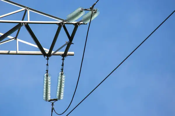 stock image High voltage tower with electrical voltage wires isolates close-up against the background of clouds. Energy industry.