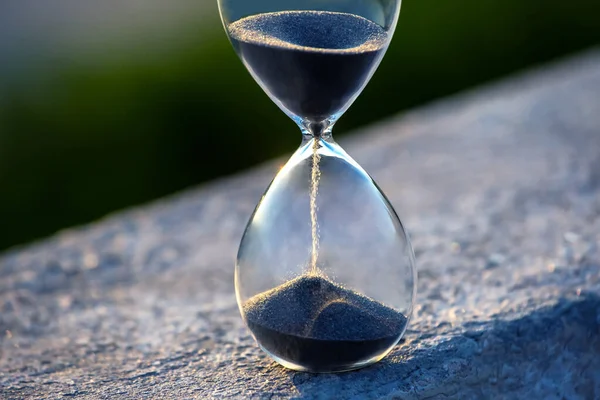 Hourglass counts the length of time against. The concept of the fluidity of life time in the universe. time and light