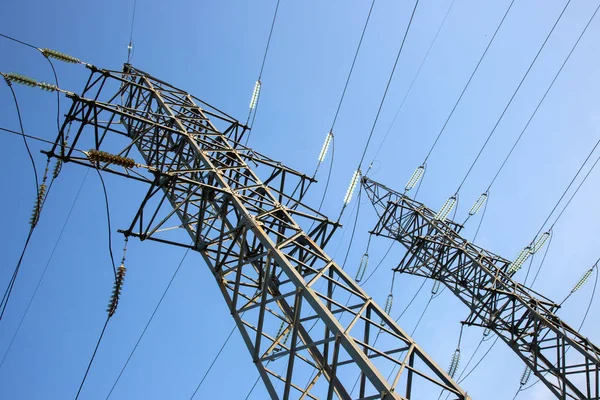 stock image power line support with wires for electricity transmission. High voltage grid tower with wire cable at distribution station. Energy industry.