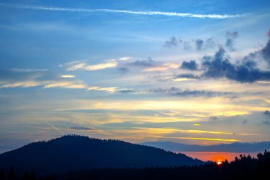 Akşam gökyüzünde parlak renkli bulutlar. Gün batımından önce gökyüzünde yemyeşil bulutlar