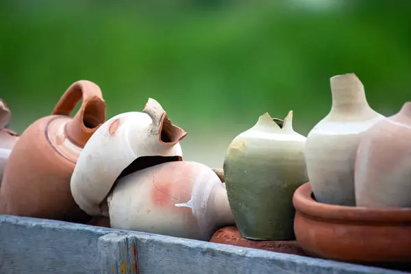 stacked together broken clay pots