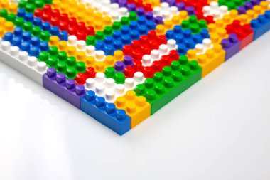Renkli yapı bloklarının soyut arkaplan dokusu. İnşaatçının renkli plastik parçalarının arka planı. Renkli oyuncak yığınları..