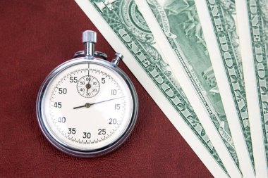 mechanical stopwatch on the background of dollars. Part time accuracy for business. business and finance time.