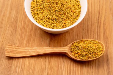 Tahta arka planda kaşıkları olan taze polenler. Organik Vitamin Sağlıklı Gıda