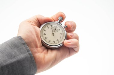 hand with a mechanical analog stopwatch on a white background. Time part precision. Measurement of the speed interval