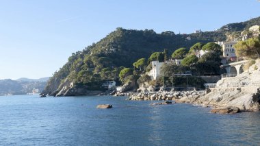 Zoagli, Ceneviz, İtalya - 15 Kasım 2018: Demiryolu köprüsü ve Zoagli Burnu ile sahili görmek. Turistler için deniz ve kaya kaldırımı. Panorama ve rahatlama. Güneşli ve sakin bir gün. - Evet. Yüksek kalite