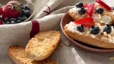 Rostini, ricotta, böğürtlen, çam fıstığı. Kahvaltıda peynirli kızarmış ekmek dilimleri. Sağlıklı yemek ve atıştırmalık. Yüksek kalite 4k görüntü