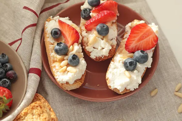Rostini, ricotta, böğürtlen, çam fıstığı. Kahvaltıda peynirli kızarmış ekmek dilimleri. Sağlıklı bir yemek ve atıştırmalık. Yüksek kalite fotoğraf