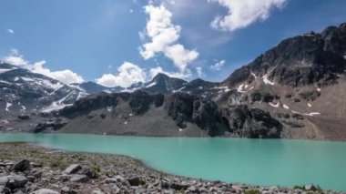 Massive Mountain Rocks Over Blue Alpine Lake,Timelapse