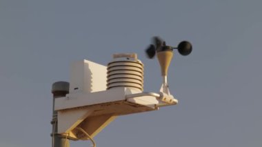 Meteoroloji istasyonunun rüzgar gülü rüzgarda döner. Video, rüzgar estiğinde rüzgar gülünün rüzgarın yönüne doğru yumuşak bir şekilde döndüğünü gösteriyor. KSA. Yüksek kalite 4k görüntü