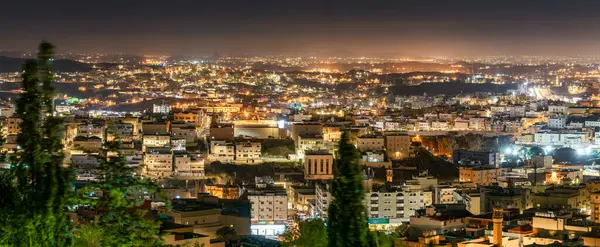 Abha City 'nin göz kamaştırıcı bir silueti var. Panorama. Abha 'nın, Suudi Arabistan' ın, gece gökyüzünün altında parlayan nefes kesici hava manzarası. Şehirler, dağlara yayılan parlak ışıklarla kaplandı.
