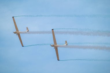 Suudi gökyüzü üzerinde senkronize planörler. İki gösterişli planör Suudi Arabistan Krallığı 'ndaki bir hava gösterisinde kusursuz bir senkronize uçuş gerçekleştiriyor ve gökyüzünde zarif izler bırakıyor. Huzurlu ama