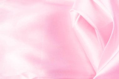 Lüks pastel pembe kumaşın, katlanmış tekstil veya sıvı dalganın ya da dalgalı ipek kumaşın soyut arkaplanı