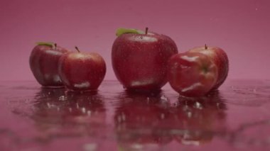 Red sweet apples jump, Natural fruits isolated on red pink background, Malus domestica, Sweet Fruits on Pink Red Background , Red Natural juicy apples and raw food filmed in studio.