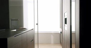 Minimalist Real Apartment. Modern Kitchen Room. Minimalist Furniture with Dining table with modern chairs. Modern Chrome Faucet. New Home. Real Luxury Design Interior. Neoclassic Style, cozy interior.