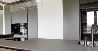 Açık Ahşap Duvar ve Zemin. Modern mutfak ve bar kahverengi sandalyeler minimalist dairede mutfak odasında. Minimalist yemek masası olan modern mutfak odası. Modern lavabolu Ev Mutfağı.