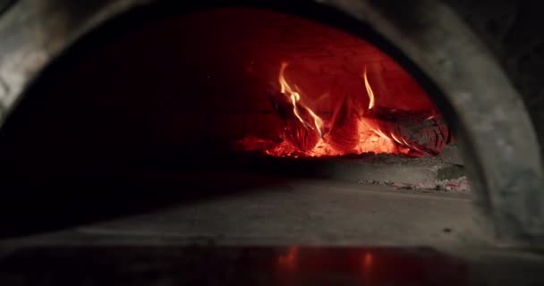 火石窯で焼かれる 暖炉の炎のクローズアップ イタリアのピザを準備する準備ができました レストラン文化準備 火で準備をしろ 木製の燃焼で動作します キッチンオーブン — ストック動画