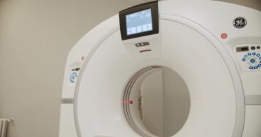 Magnetic Resonance Imaging machine. Hospital room with tomograph. Modern technologies in medicine. View of contemporary CT machine with table installed in light laboratory on modern hospital
