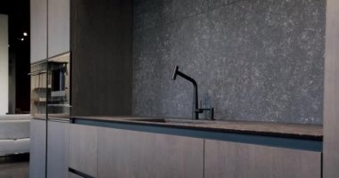 Real Estate. Luxury kitchen with an island. Modern interior in luxury house. Modern Chrome Faucet. Minimalist design in New Home. Real Luxury Design Interior. Neoclassic Style, cozy interior.