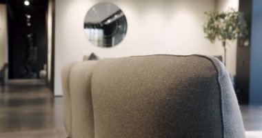 Luxury Modern House Interior With Corner Sofa, Chairs and Bookshelf. Luxury Elegant Room. Real Estate private home. Modern contemporary Minimalist living room with beige and white furniture.