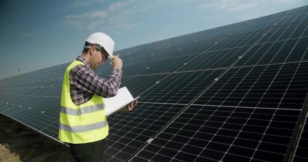 Positive Adult Man Uniform Checking Photovoltaic Panels Making Notes Journal — Wideo stockowe
