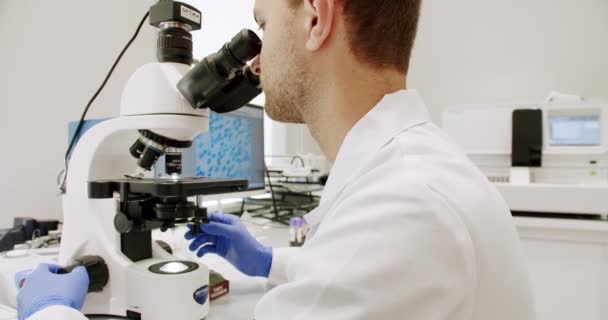 Male Doctor Using Microscope Laboratory Man Lab Coat Latex Gloves — 비디오