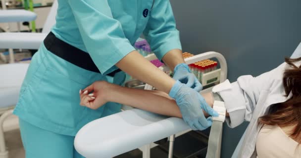 Handheld Shot Female Assistant Uniform Inserting Syringe Needle Vein Putting — Stockvideo