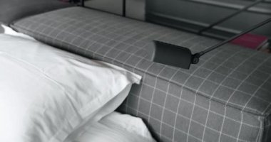 Minimalist Modern Bedroom Interior wiht bed and many pillows, modern black light lamp. minimalistic scandinavian style of interior. Elegant and Simple Bedroom With a King Sized Bed. Real Estate.