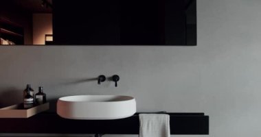 Luxury Bathroom Interior in black, gray and white colors, Minimalist interior with wood in brown colors and bathroom accessories,mirror and shower head,bathtub modern design. Luxury Bathroom Interior.