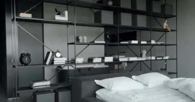 Elegance interior design with black and white colors. Minimalistic scandinavian style of interior. Interior with bookshelf on the wall. Real Estate. Interior of modern luxury bedroom with furniture.